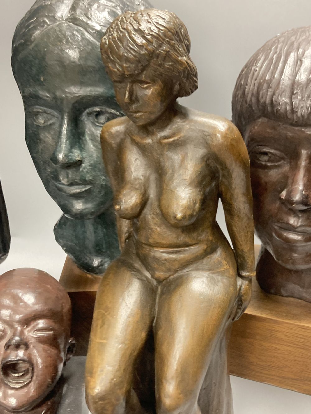Five bronzed plaster and resin figures / busts, seated lady 39cm